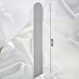 White nail file on a white fabric background with measurement text